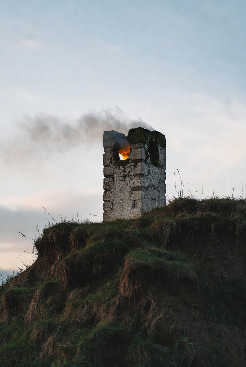 Cluster of round chimneys above a green hillside